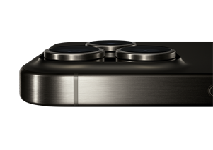 The top portion of the Natural Titanium iPhone 15 Pro placed horizontally, showing the Pro 3 camera system on the back of iPhone 15 Pro